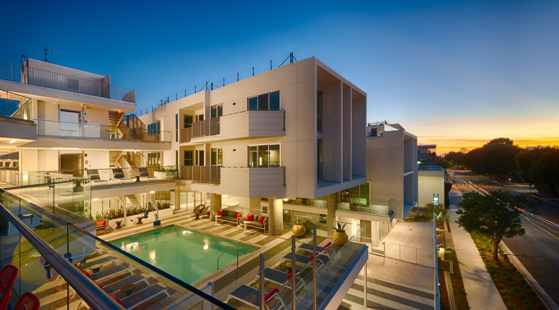 Welcome home a building with a pool and the night sky in the background