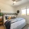 a bedroom with a bed and a fan