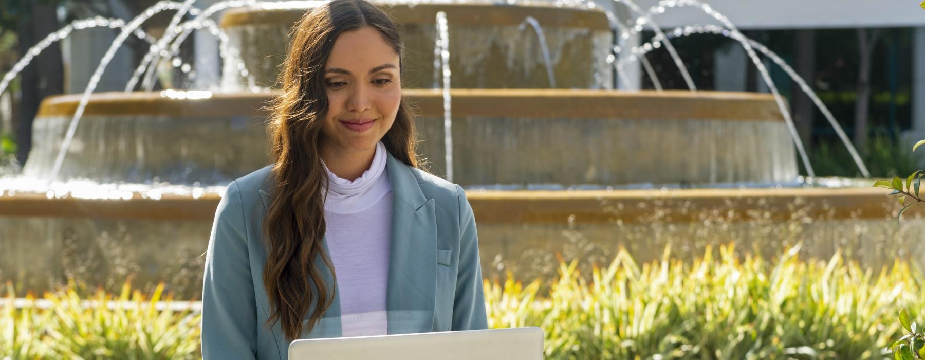 a woman holding a laptop