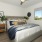 a bedroom with a bed and a table